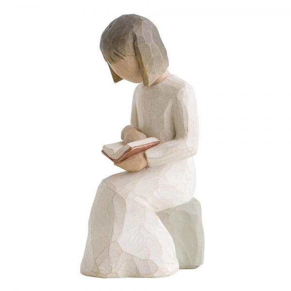 Wisdom by Willow Tree. Figure in cream dress seated on a gray rock, reading a book