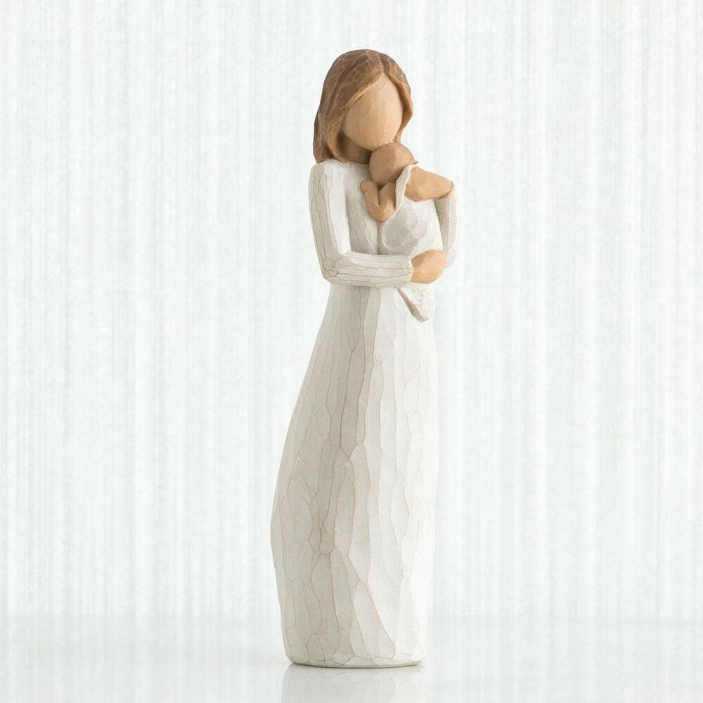 Angel of Mine by Willow Tree. Standing figure in cream dress, holding infant in cream blanket to her chest