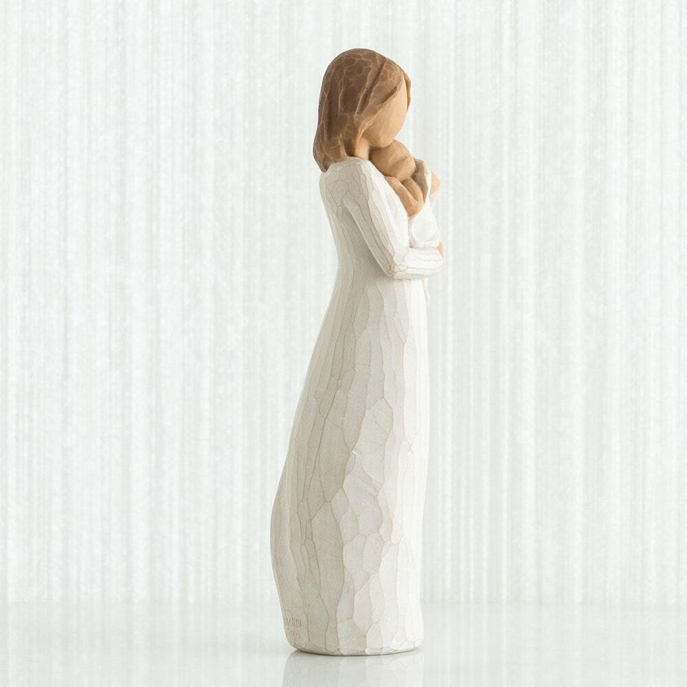 Angel of Mine by Willow Tree. Standing figure in cream dress, holding infant in cream blanket to her chest