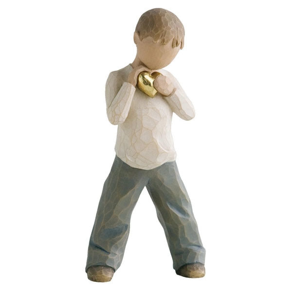 Heart of Gold by Willow Tree. Standing boy figure in cream shirt and blue jeans, holding gold-leaf heart with both hands to his chest