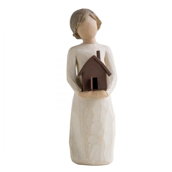 Mi Casa by Willow Tree. Standing figure in cream dress, holding dimensional metal house with chimney and open front door in her arms