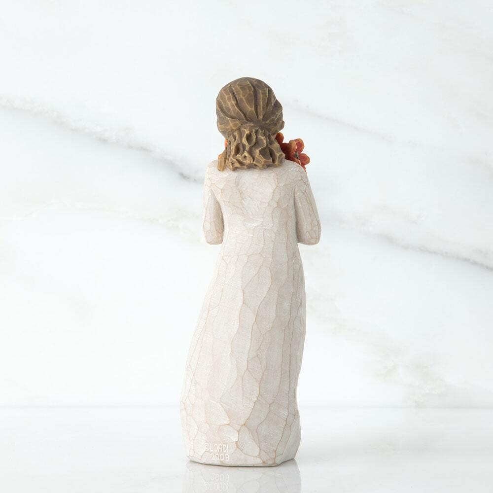 Back View - Standing figure in cream dress, holding large bouquet of red-orange poppies up to her face