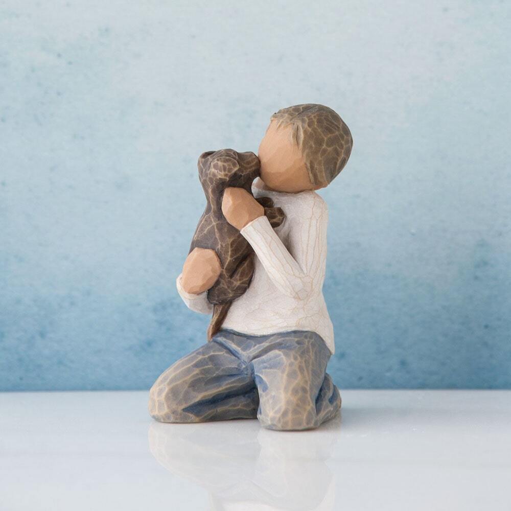 A boy carrying a dog figure