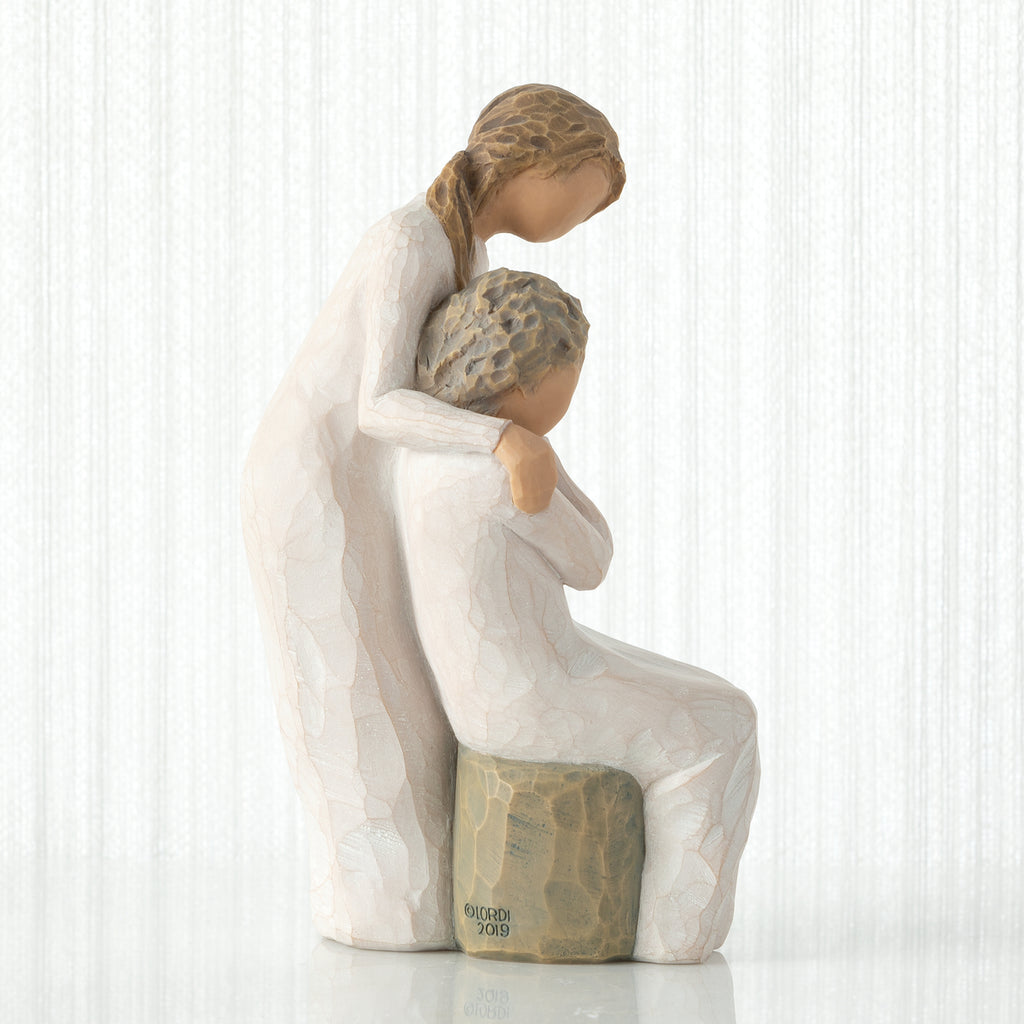 Loving My Mother by Willow Tree. Seated older female figure in cream dress, with younger female in cream dress, standing at her shoulder, hands clasped in embrace