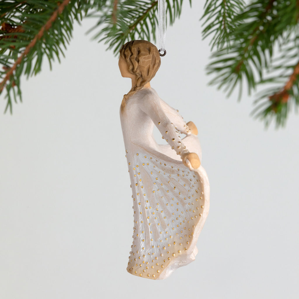 Butterfly Ornament by Willow Tree. Figure in cream dress, holding sides of her skirt out with both hands. Skirt has carved markings of a monarch butterfly, dotted with gold leaf. Hook and loop affixed to figure's head